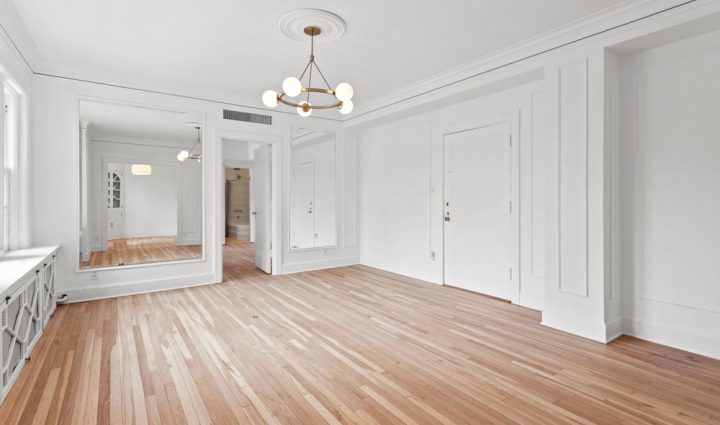 empty room of the newly renovated house, white painted walls, and a wooden floor