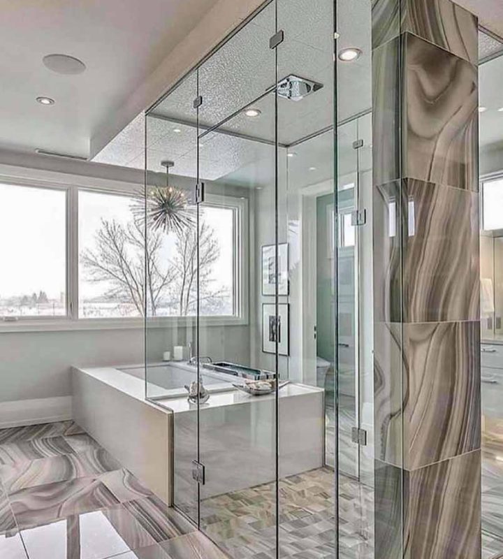 a newly remodeled luxury master bathroom. full glass shower enclosure, a bathtub near the windows